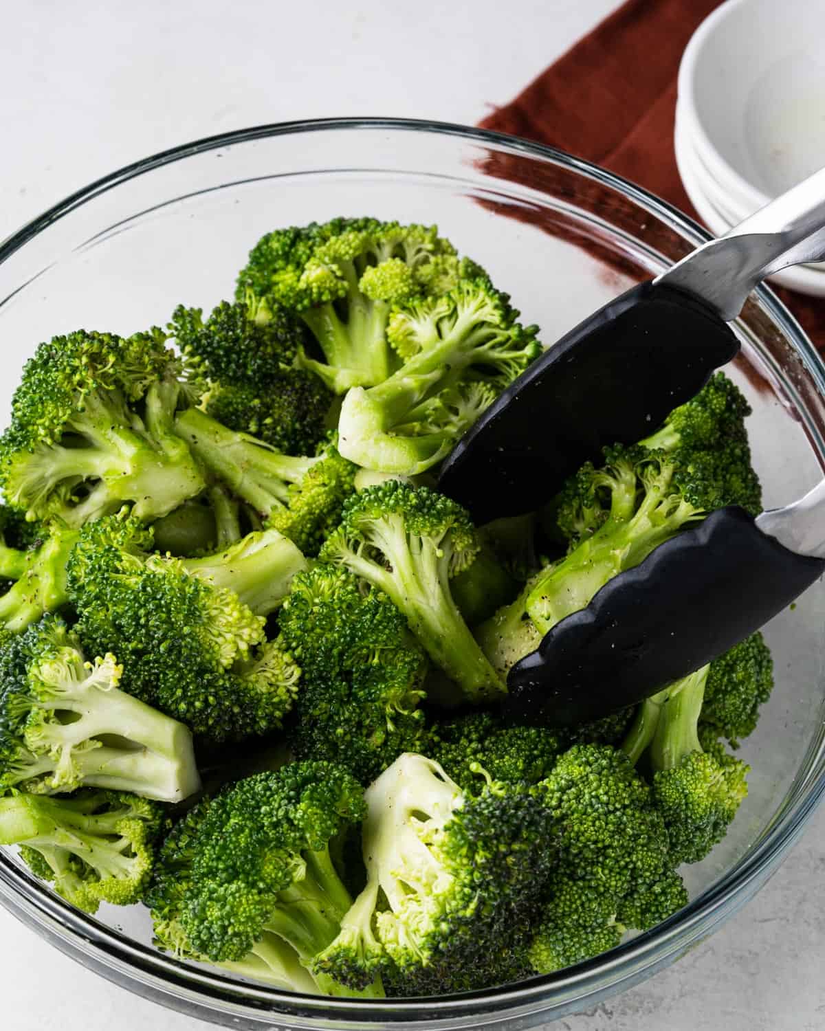 Mixing air fryer broccoli ingredients together