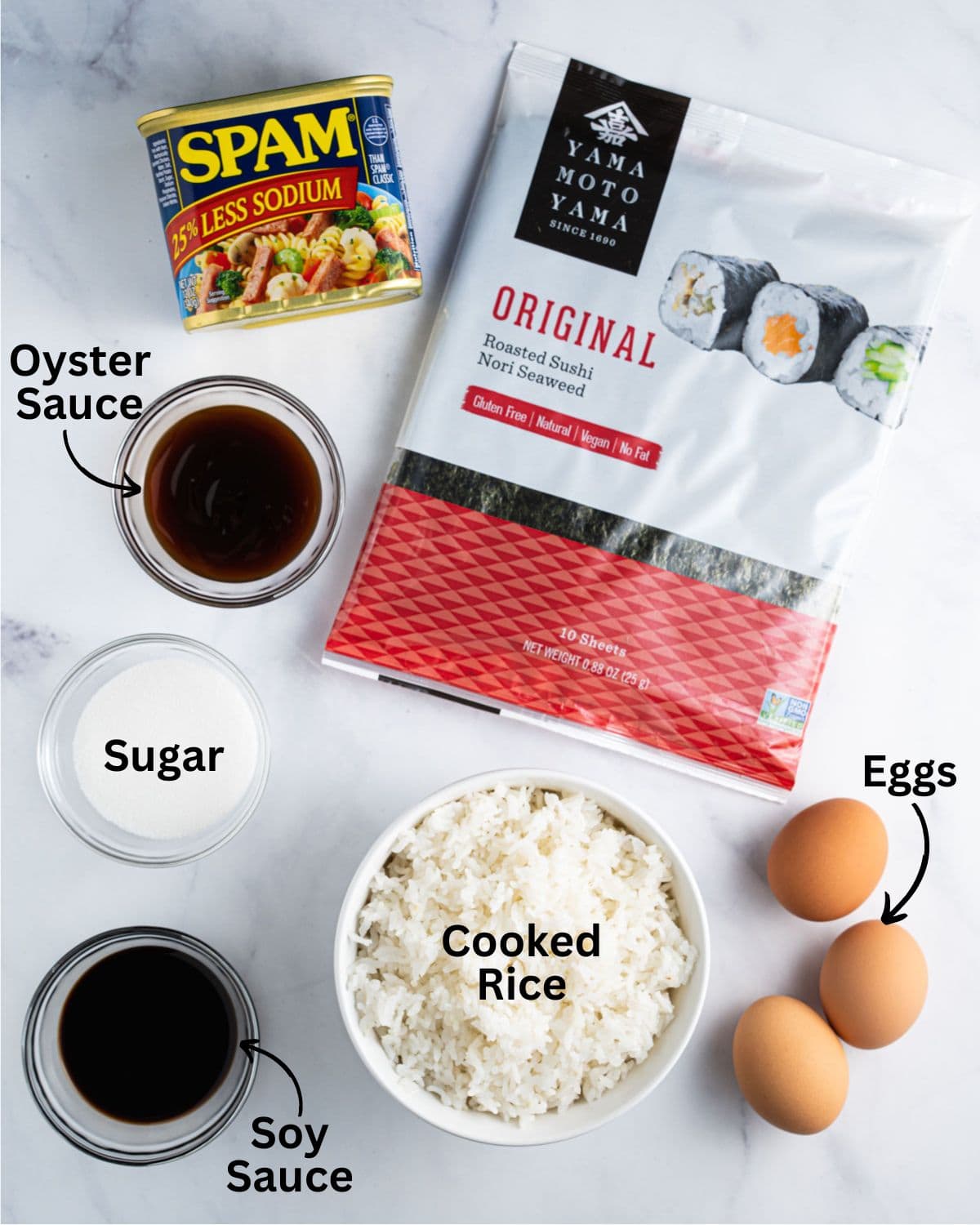 Ingredients needed for spam musubi with eggs: cooked rice, spam, eggs, nori sheet, oyster sauce, soy sauce and sugar.
