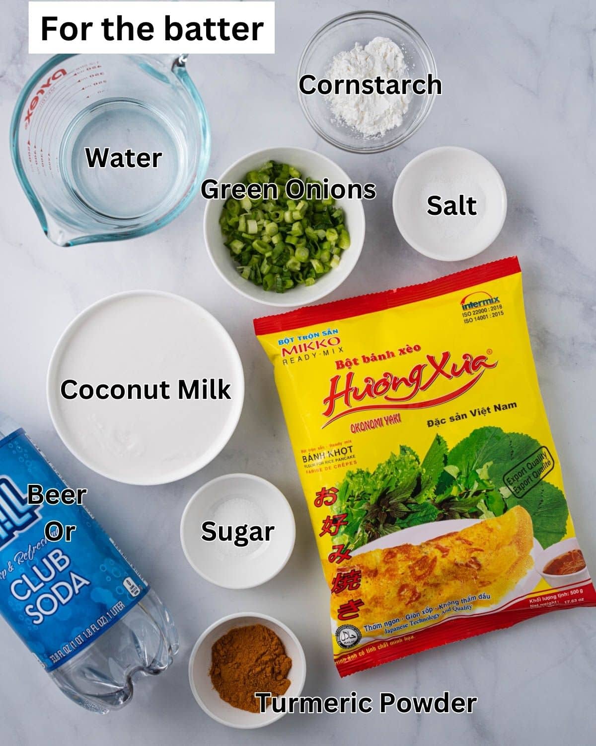 Ingredients for the banh xeo batter: Banh Xeo ready mix powder, cornstarch, turmeric powder, salt, sugar, water, coconut milk, club soda, and sliced green onions.