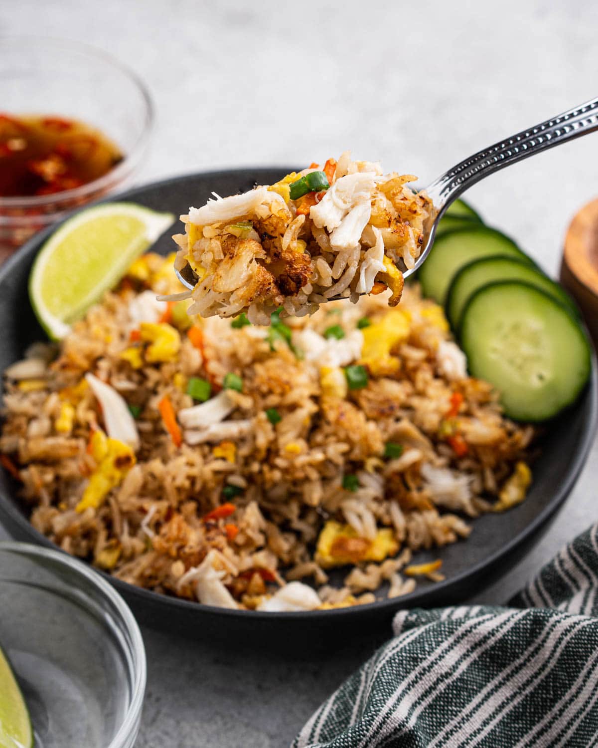 Spoon holding up crab fried rice.