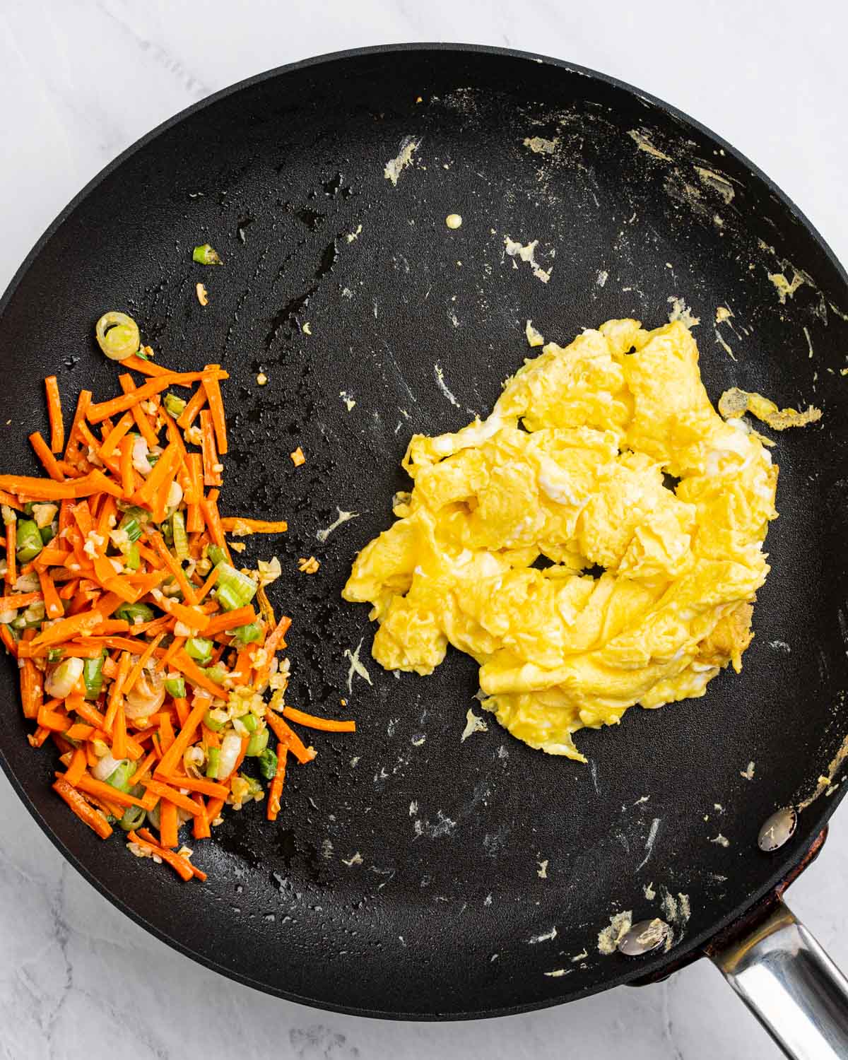 pan with vegetables on one side and scrambled eggs on the other.