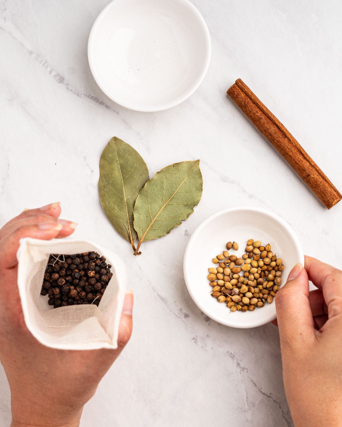 Adding herbs and spices into cheesecloth.
